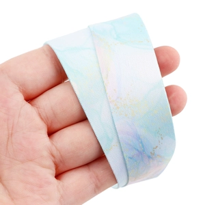 Detail of soft marble pattern lanyard with blue, pink, and gold watercolor texture