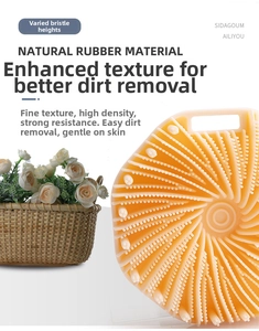 Detail of orange natural rubber bath brush featuring ergonomic spiral bristle design