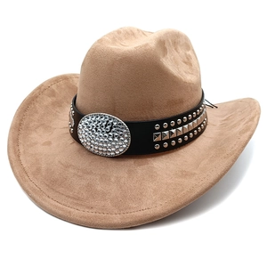Close-up of suede cowboy hat with black belt, metallic studs and rhinestone buckle