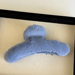 Close-up of a soft fuzzy blue plush hair claw clip for autumn and winter daily hairstyles