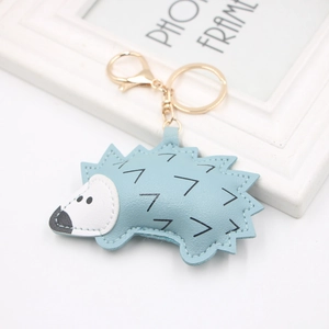 Cartoon hedgehog leather keychain in sky blue with gold metal ring and lobster clasp