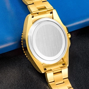 Macro close-up of polished stainless steel watch case back on blue and black leather