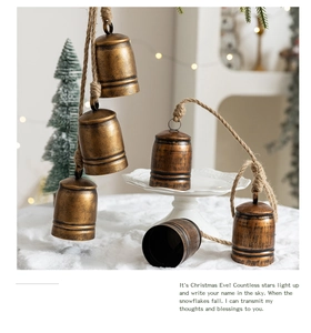 Rustic bronze metal bells with jute rope close-up showing antique texture for Christmas
