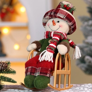Detailed view of a Christmas snowman plush doll sitting on a brown rocking chair ornament