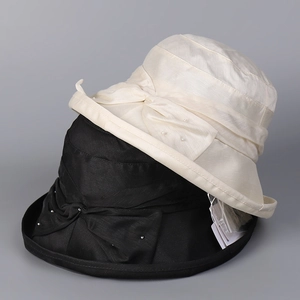 Detail of Lyocell linen sun hats featuring elegant side bows and delicate pearl ornaments