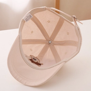 Detail view of cotton baseball cap interior with sweatband and adjustable buckle