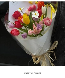 Detail of colorful tulips bouquet wrapped with natural raffia string and Flora gift card