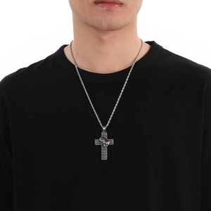 Male model wearing silver cross pendant with praying hands and twisted rope chain detail