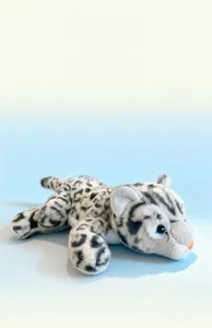 Close-up of cute plush snow leopard with blue eyes and soft spotted fur details