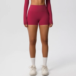 Close-up of berry red high-waisted yoga shorts with butt-lifting fit and sleek fabric