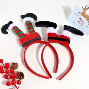 Detailed view of plush Christmas headbands with elf and Santa legs on a festive setup