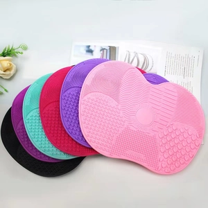Colorful apple-shaped silicone makeup brush cleaning pads with textured washing surfaces
