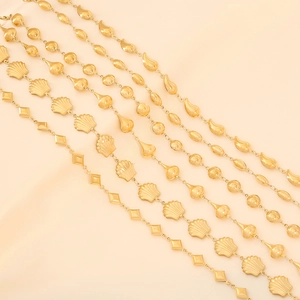 Detailed view of gold metal necklaces featuring shell, heart and teardrop shaped charms