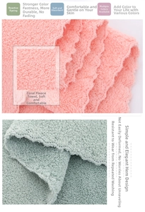 Close-up of soft pink and green coral fleece towels featuring wavy scalloped edges
