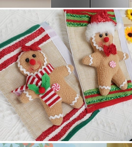 Detail of gingerbread man Christmas gift bags in red and green plush fabric and sequins
