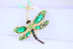 Detailed close-up of a green rhinestone dragonfly keychain with faceted gemstones