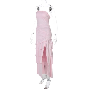 Detail of pink strapless maxi dress featuring tiered ruffle hem and high side slit