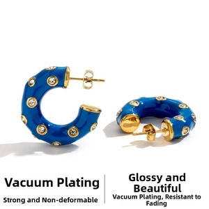 Detail of blue C-shaped hoop earrings with gold plating and embedded crystals