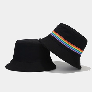 Detail of black cotton bucket hats showing plain style and rainbow striped ribbon trim