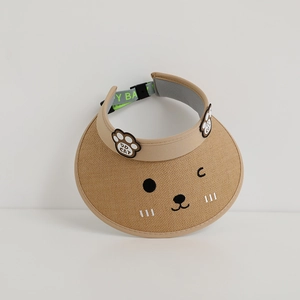 Detail of straw woven visor with cute cat paw embroidery and adjustable strap for kids