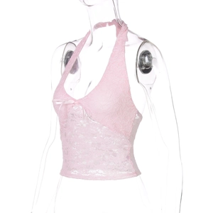 Detail of pink lace halter top featuring delicate fabric textures and a sweet bow accent