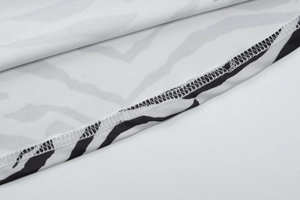 Detail of zebra print fabric featuring high-quality overlock stitching and soft texture