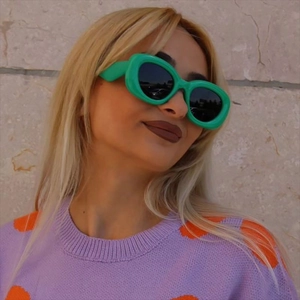 Fashionable bright green thick frame oval sunglasses with dark lenses for a retro y2k style
