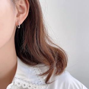 Elegant 925 sterling silver braided twist hoop earrings worn on ear for minimalist look