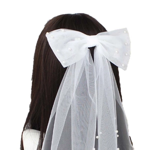 White tulle bridal bow hair clip with pearls and long wedding veil for women