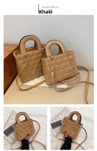 Detailed view of the khaki heart-quilted lady bag featuring golden hardware and charm