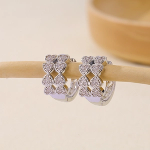 Macro shot of silver heart hoop earrings with sparkling cubic zirconia pavé stones
