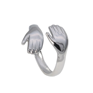 Polished silver stainless steel hugging hands open ring in a minimalist style
