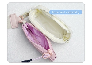 Close-up of internal capacity of dual zippered nylon wristlets in pink and white