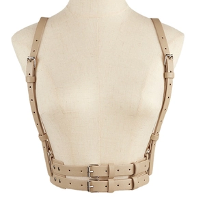 Punk style beige leather harness belt with shoulder straps and metal rings on model