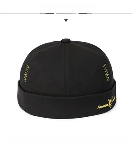 Detail of yellow Freedom embroidery and Z-shaped stitching on black cotton Miki hat