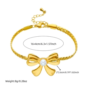 Detail view of gold woven chain bracelet with pearl bow pendant and size specifications