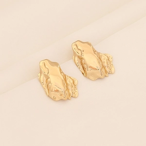Irregular lava texture stainless steel studs with a gold finish on textured fabric