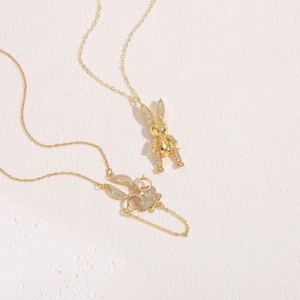 14K gold plated rabbit pendant necklace with zircon stones on natural stone background