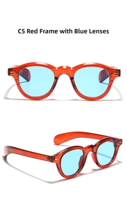 Detail of retro round sunglasses with transparent red frames and light blue lenses