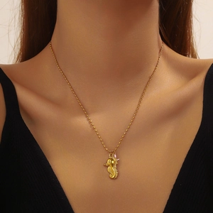 Golden seahorse pendant necklace for women on neck with minimalist bead chain link
