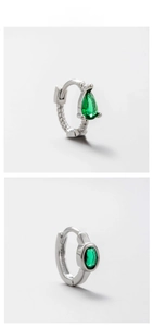 Detailed macro view of silver screw ear cuffs with pear and oval green zircon stones