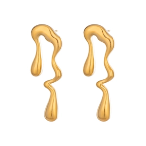 Gros plan sur les boucles d'oreilles dorées en forme de goutte d'eau irrégulière
