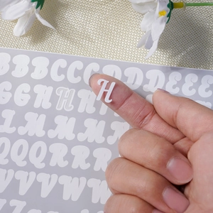Detail view of mini 0.5-inch white vinyl alphabet stickers for DIY scrapbooking crafts