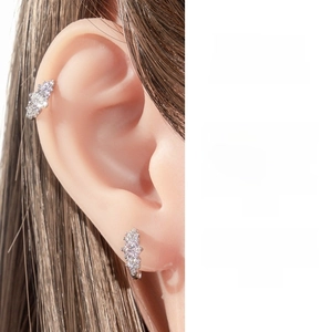 Detail showing a minimalist silver zircon ear cuff and stud earring set for women