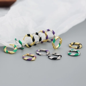 Close-up of S925 silver twist hoop earrings with colorful enamel stripes in gold and silver