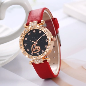 Detail of starry dial women's watch with red leather strap and heart motif