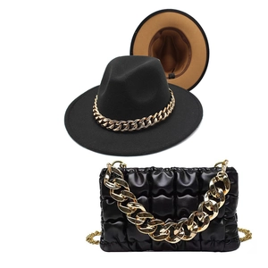 Detail of black wool fedora with gold chain and matching quilted chain handbag