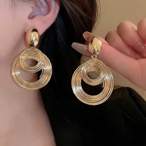 Layered gold geometric twist hoop earrings for women in a chic metallic design