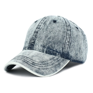 Close-up of vintage washed denim baseball cap showing six-panel stitch and fabric texture