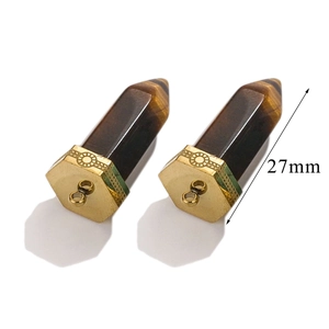 Macro view of a 27mm tiger eye hexagonal prism pendant with a golden floral metal base